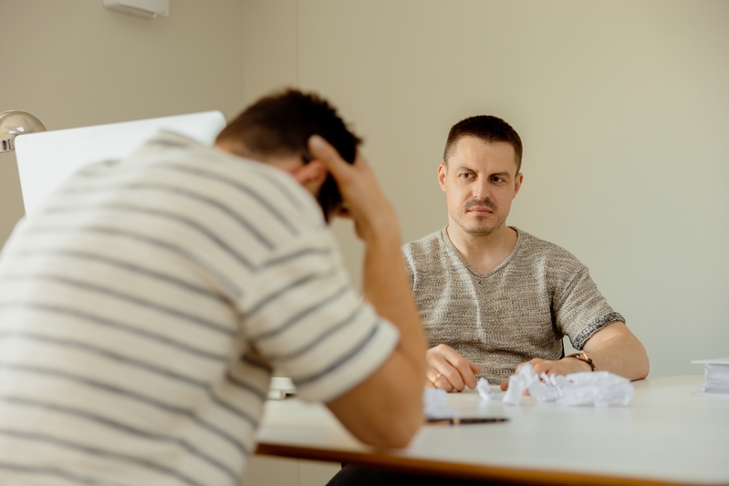 Stressed young office employee has problems at work. Boss is angry, risk of dismissal. Mental health. Overwhelmed by working. Deadline, stress. Mistake at work, negative emotions.